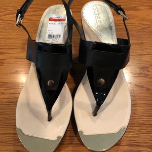 Guess brand, black wedge sandals w/golden trim.